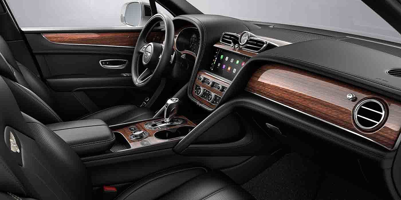 Bentley Hangzhou - Gongshu Bentley Bentayga EWB interior with a Crown Cut Walnut veneer, view from the passenger seat over looking the driver's seat.